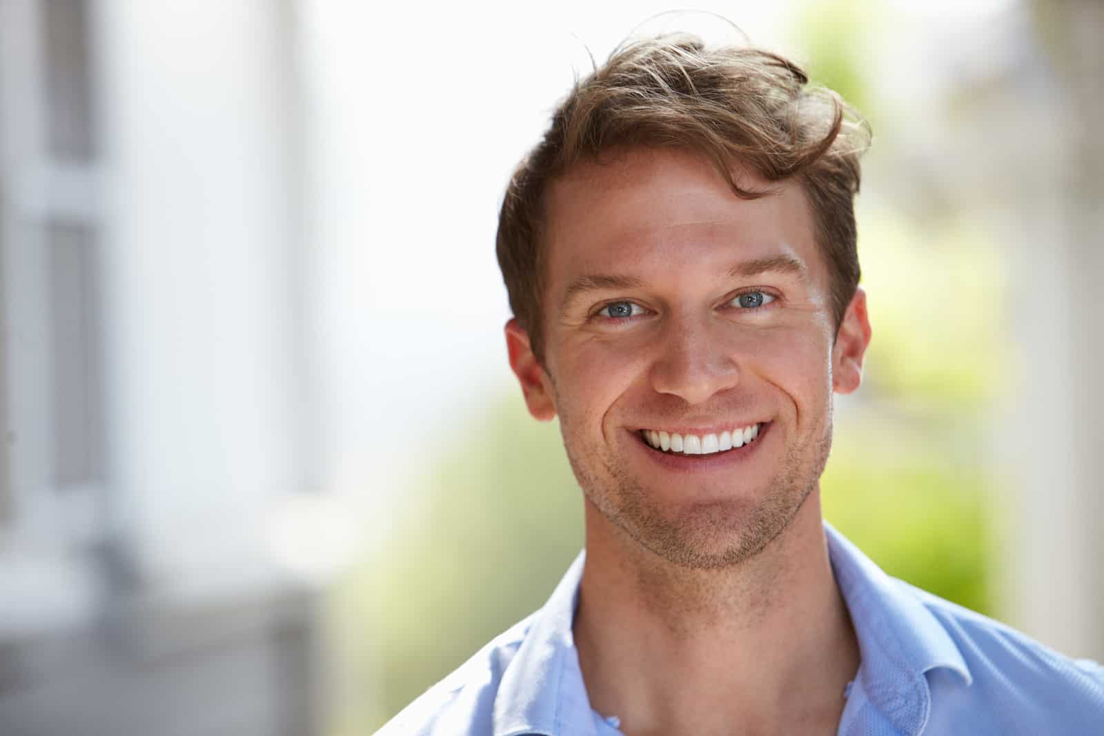 young man smiling while posing to camera