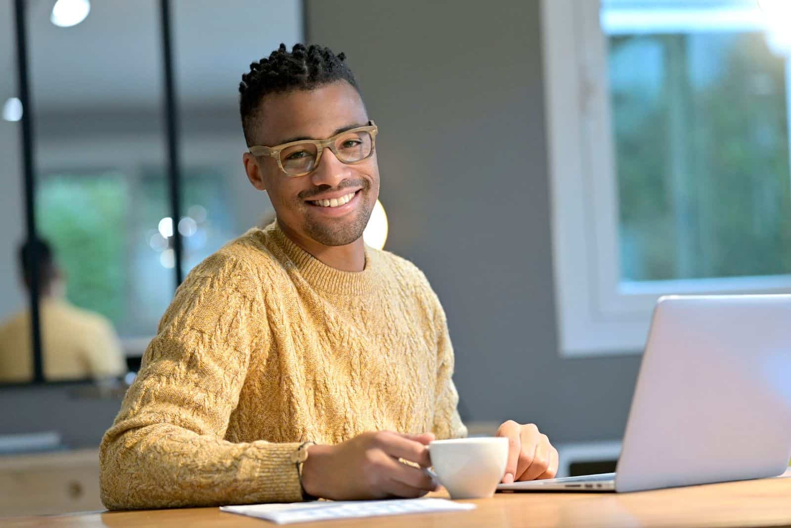 a man is sitting at a desk in the office