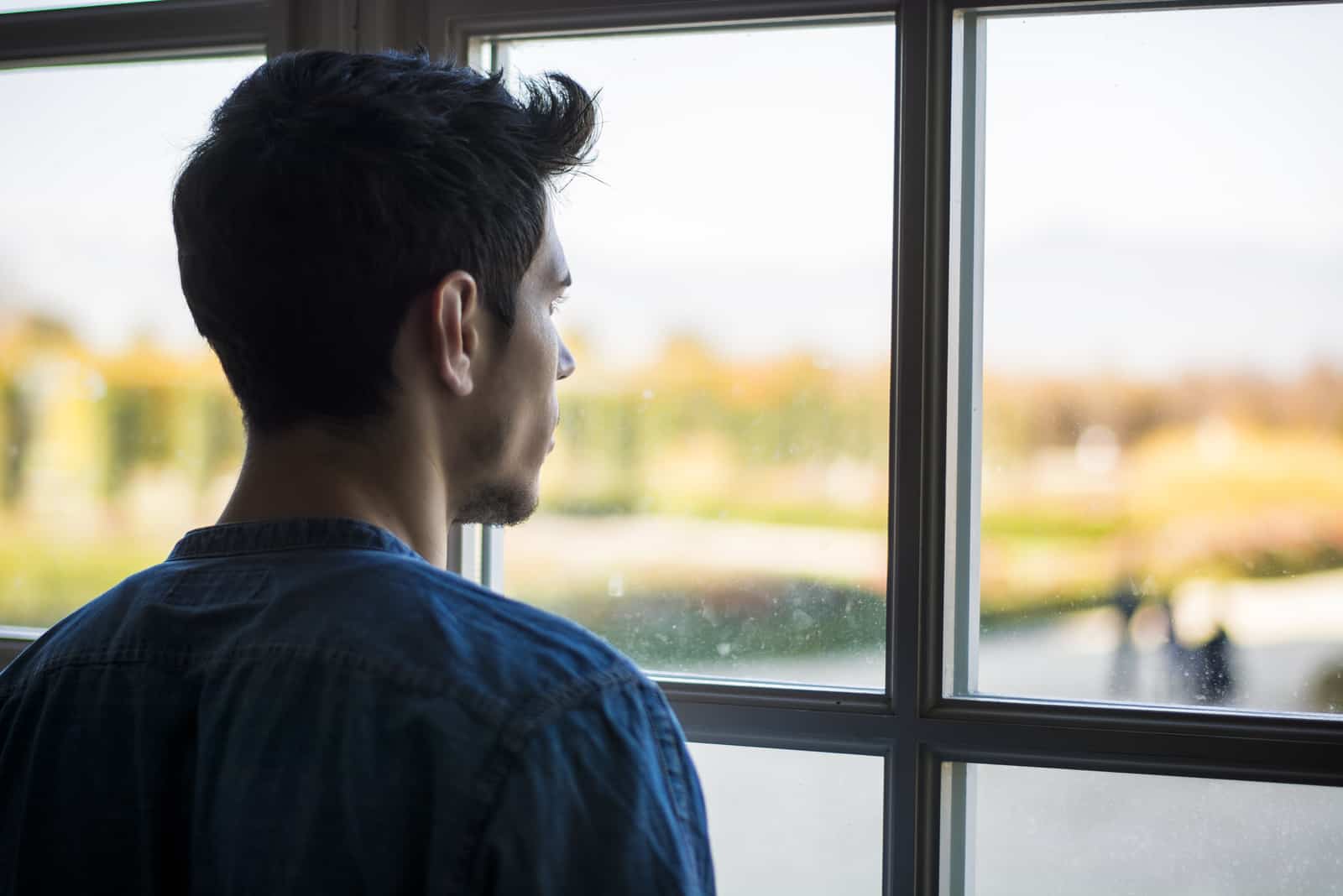 man looking through window