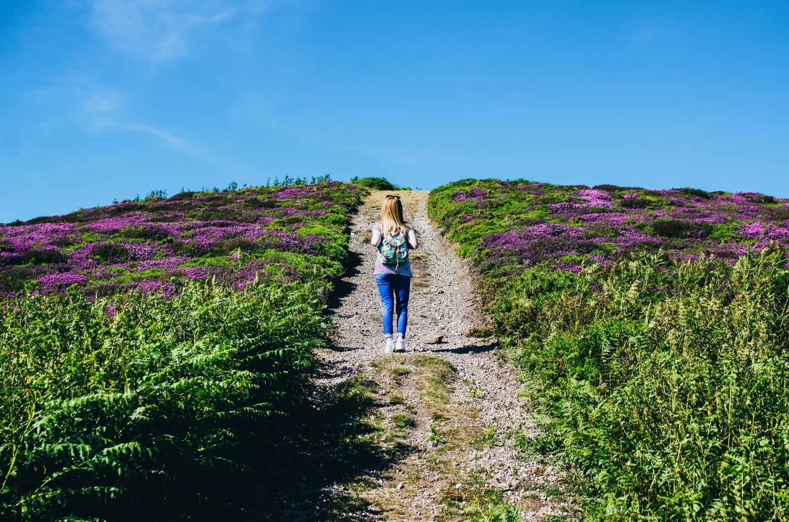 short woman walking through a field