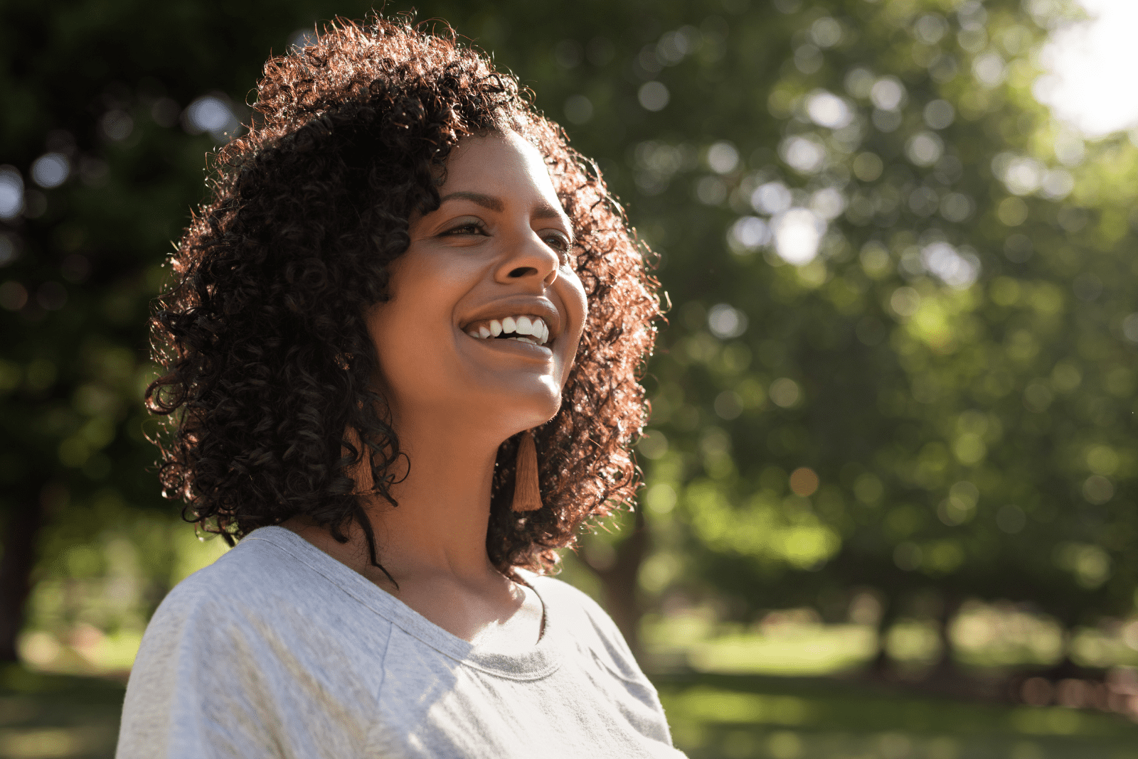 smiling woman standing in the park