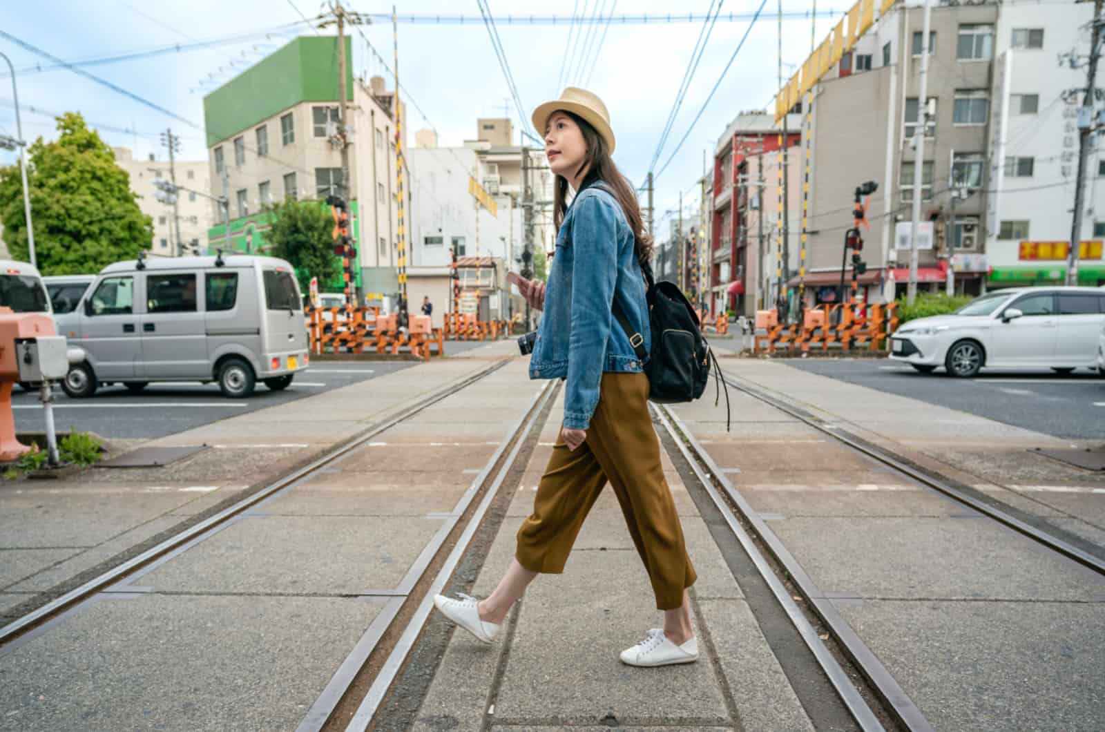 woman walking across the street