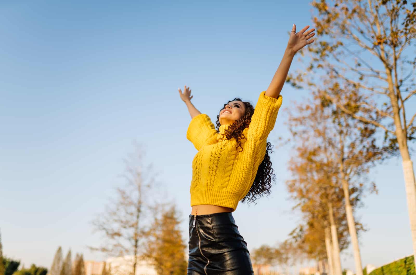 young woman with hands in the air