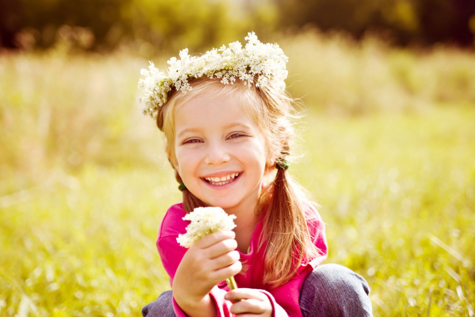 Portrait of a little girl in wreath of flowers
