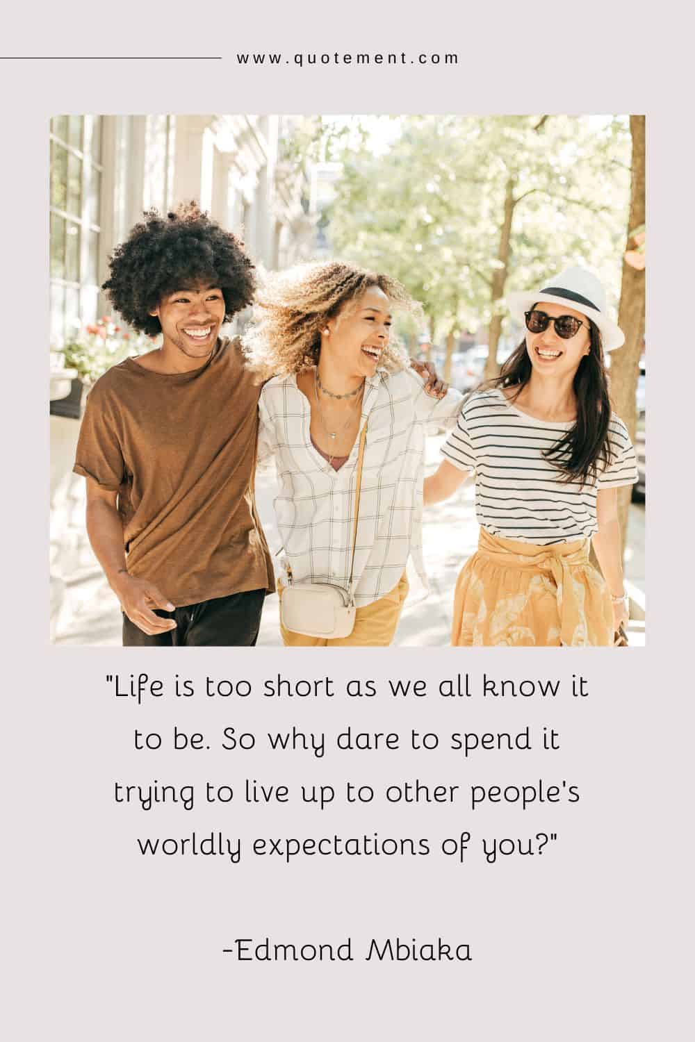 Three smiling friends walking arm in arm, expressing their happiness in a hug.