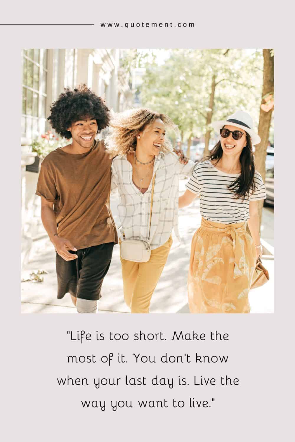 three smiling friends strolling together sharing a hug as they walk