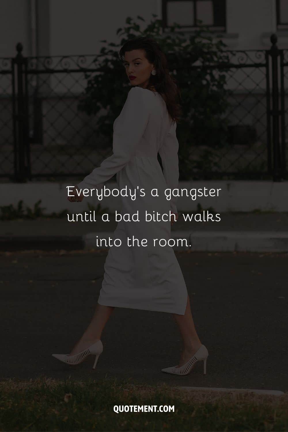 Stylish woman in heels walking confidently representing gangster caption.