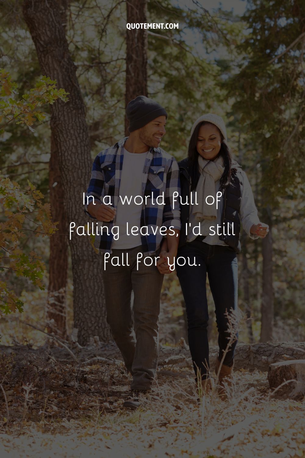 romantic couple hand in hand on leaf-covered ground