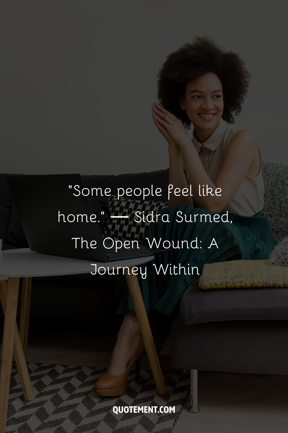 A relaxed woman with an afro hairstyle engages in a casual work session at home
