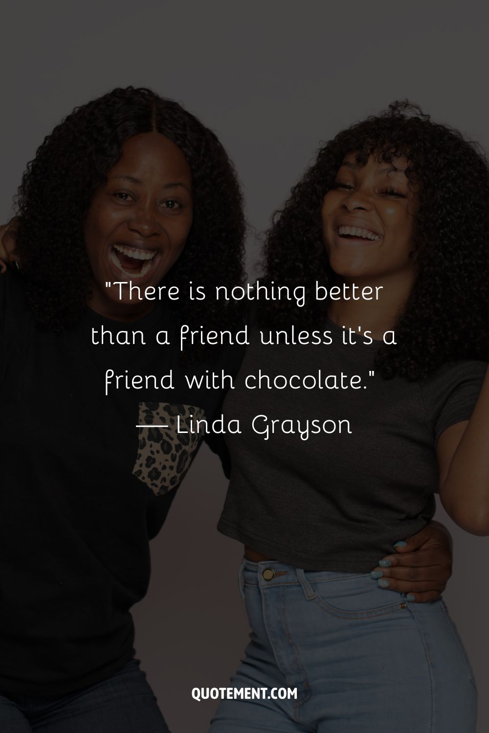 A close-up of two happy women standing shoulder to shoulder
