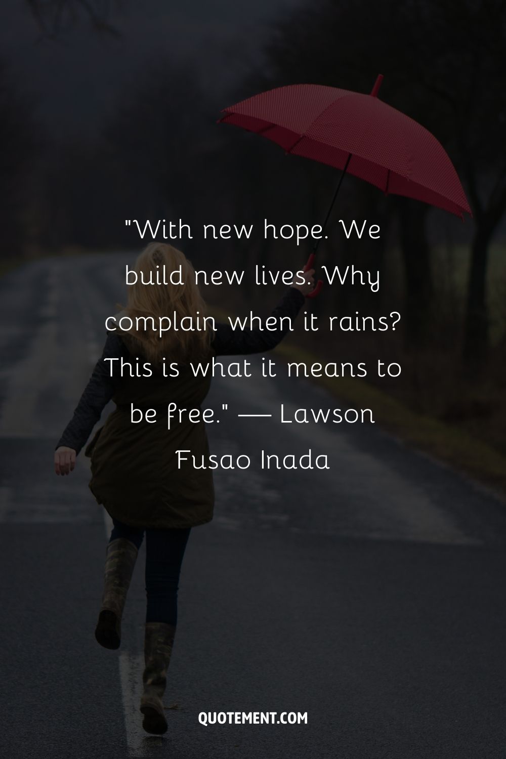 A woman and her red umbrella against the backdrop of a foggy road
