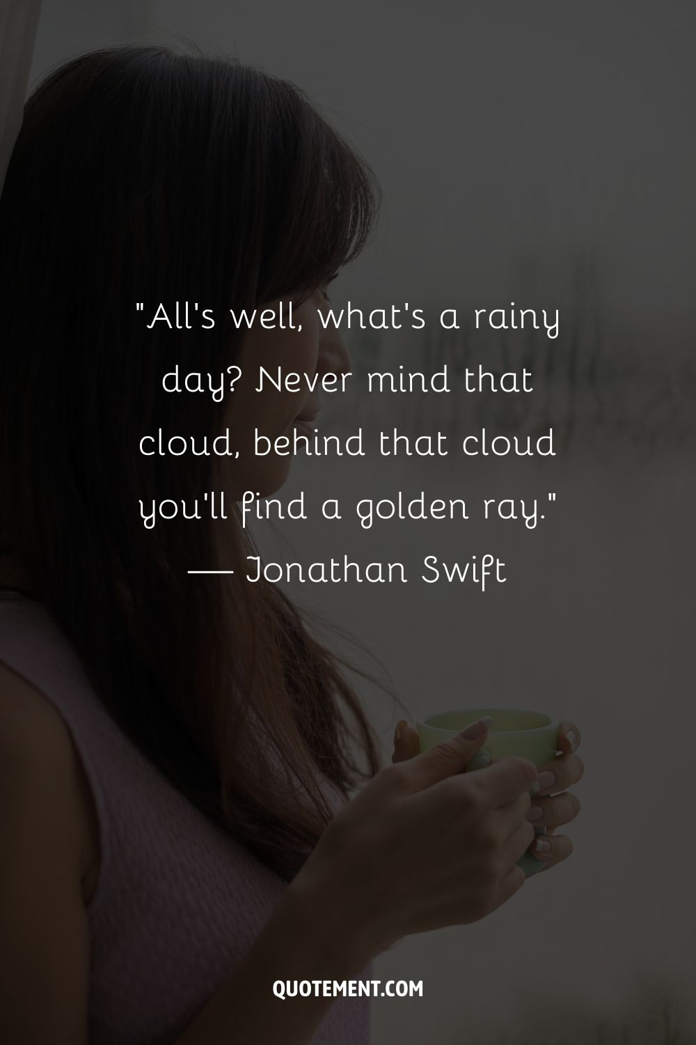 A woman enjoying a hot beverage by a window on a rainy day
