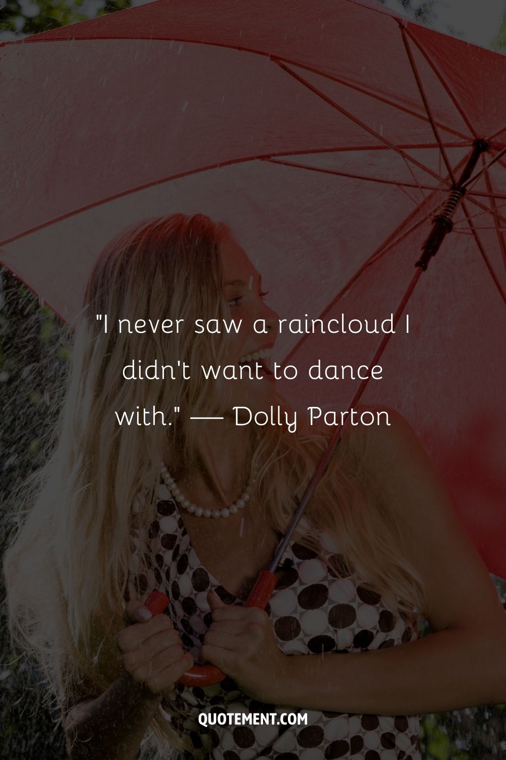 A woman enjoying the shelter of her red umbrella on a rainy day
