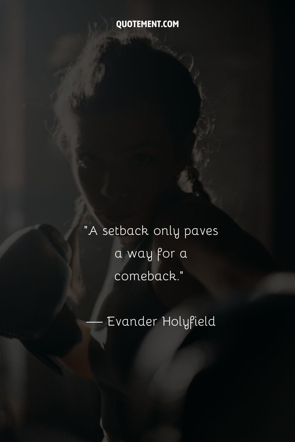 A woman with her hair in braids, poised in a classic boxing guard position
