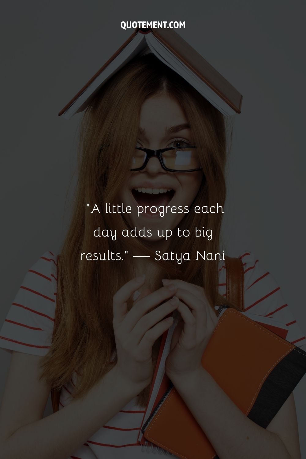 A joyful redhead with a book atop her head representing a positive inspiring quote for students
