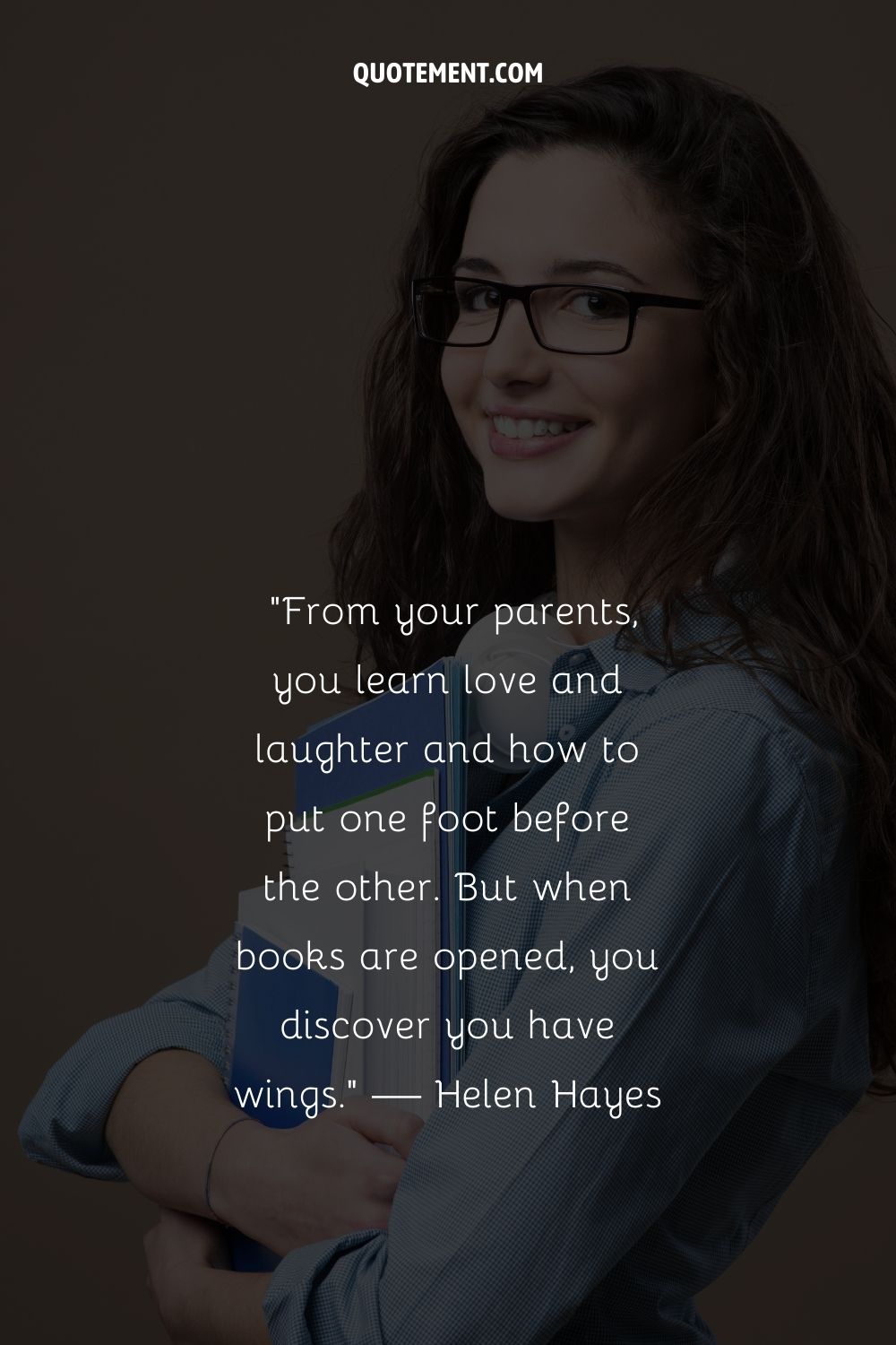 A smiling woman holding a book representing the top motivational quote for students
